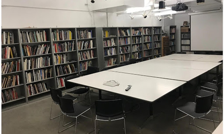 Bookshelves and a large table in the Sculpture Resource Room