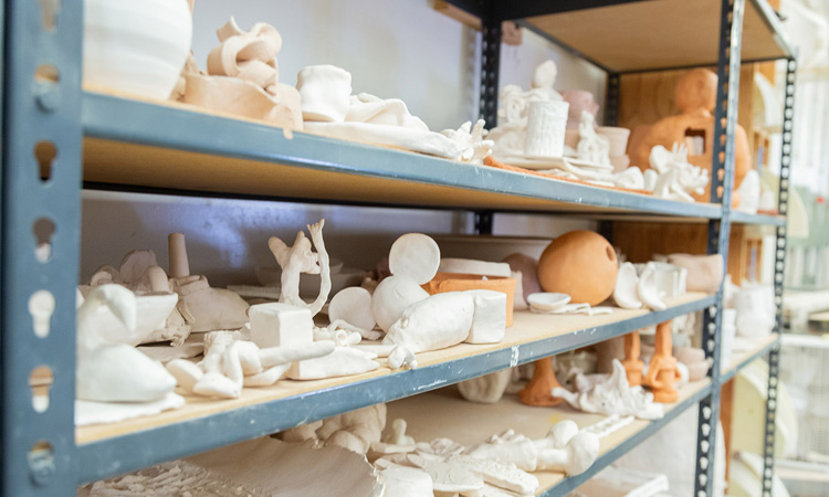 Shelves holding small ceramic works