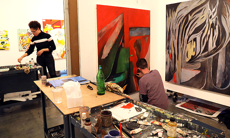 Students painting in a studio