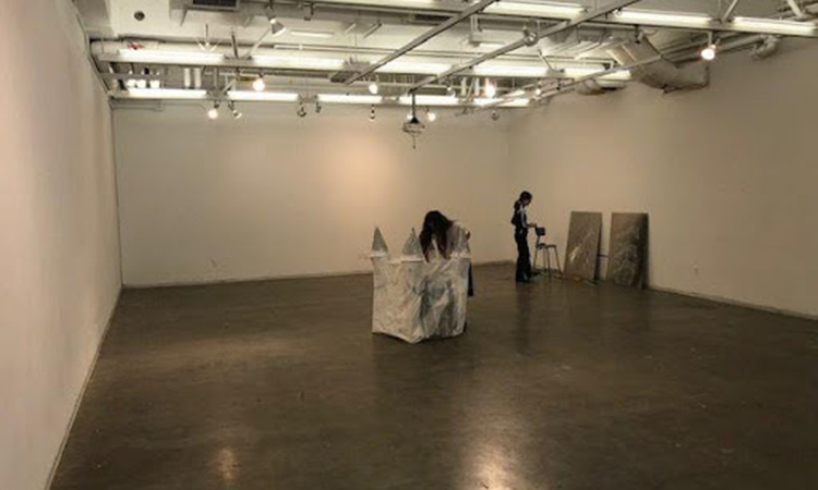 Student installing work in the Sculpture White Room