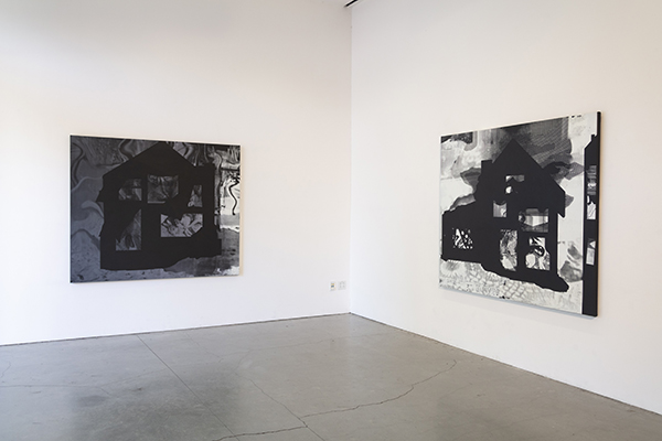 Monochromatic paintings hanging on gallery walls
