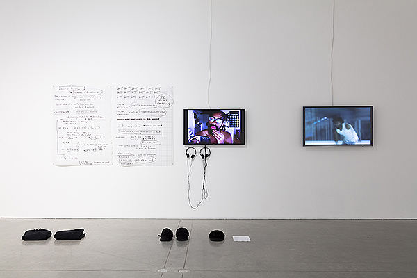 Drawings and video monitors on a wall