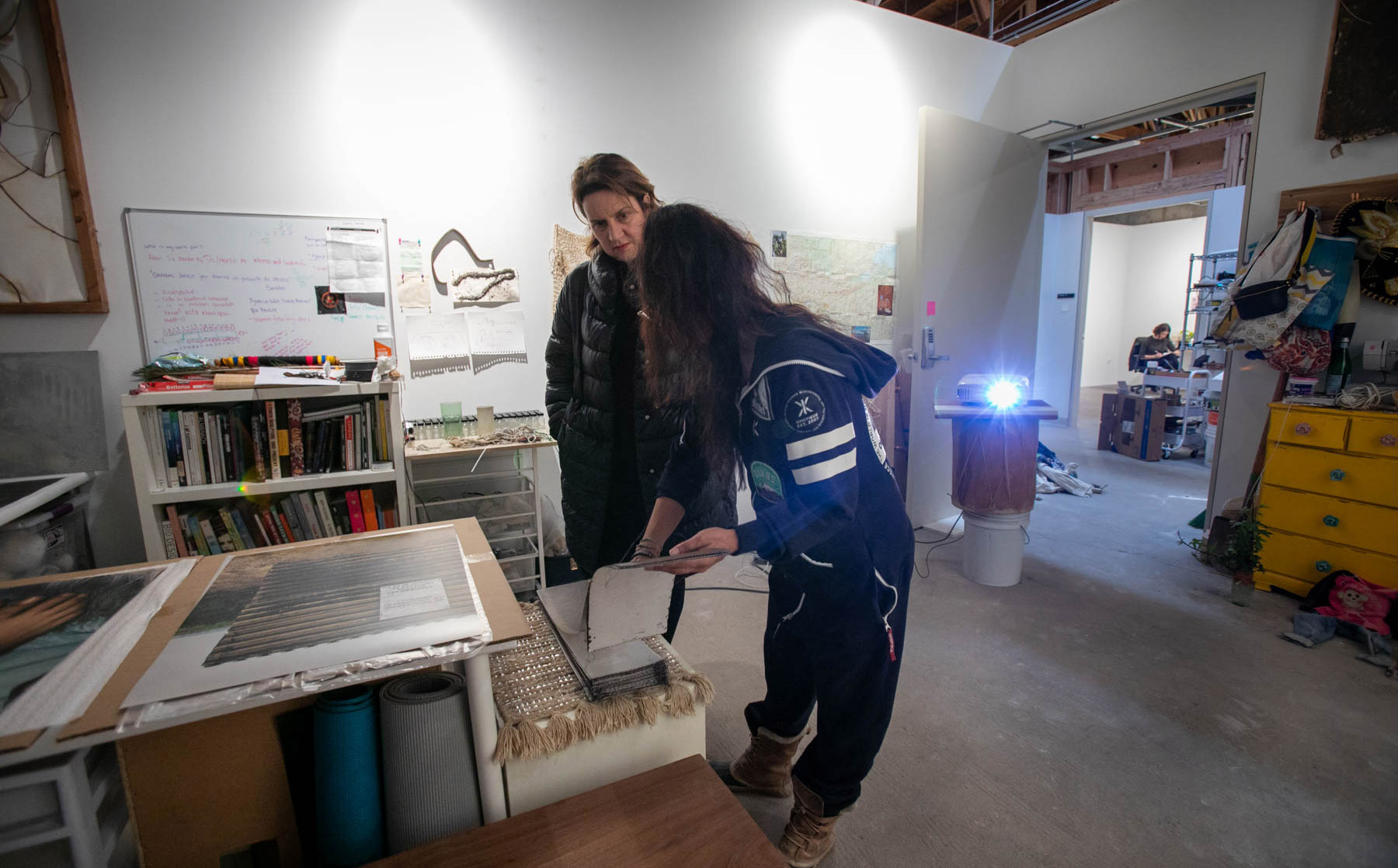 Student and faculty talking in a studio