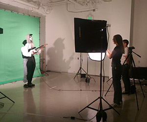 Student record video in front of a green screen