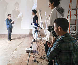 Students and faculty working with cameras and projectors