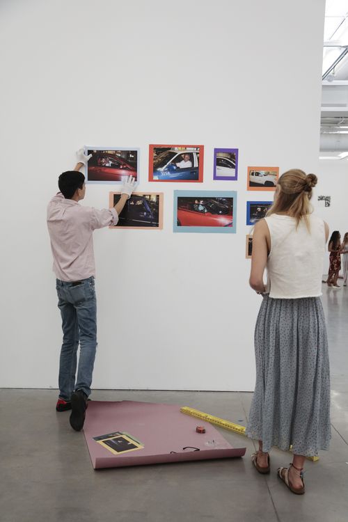 two students installing photographs