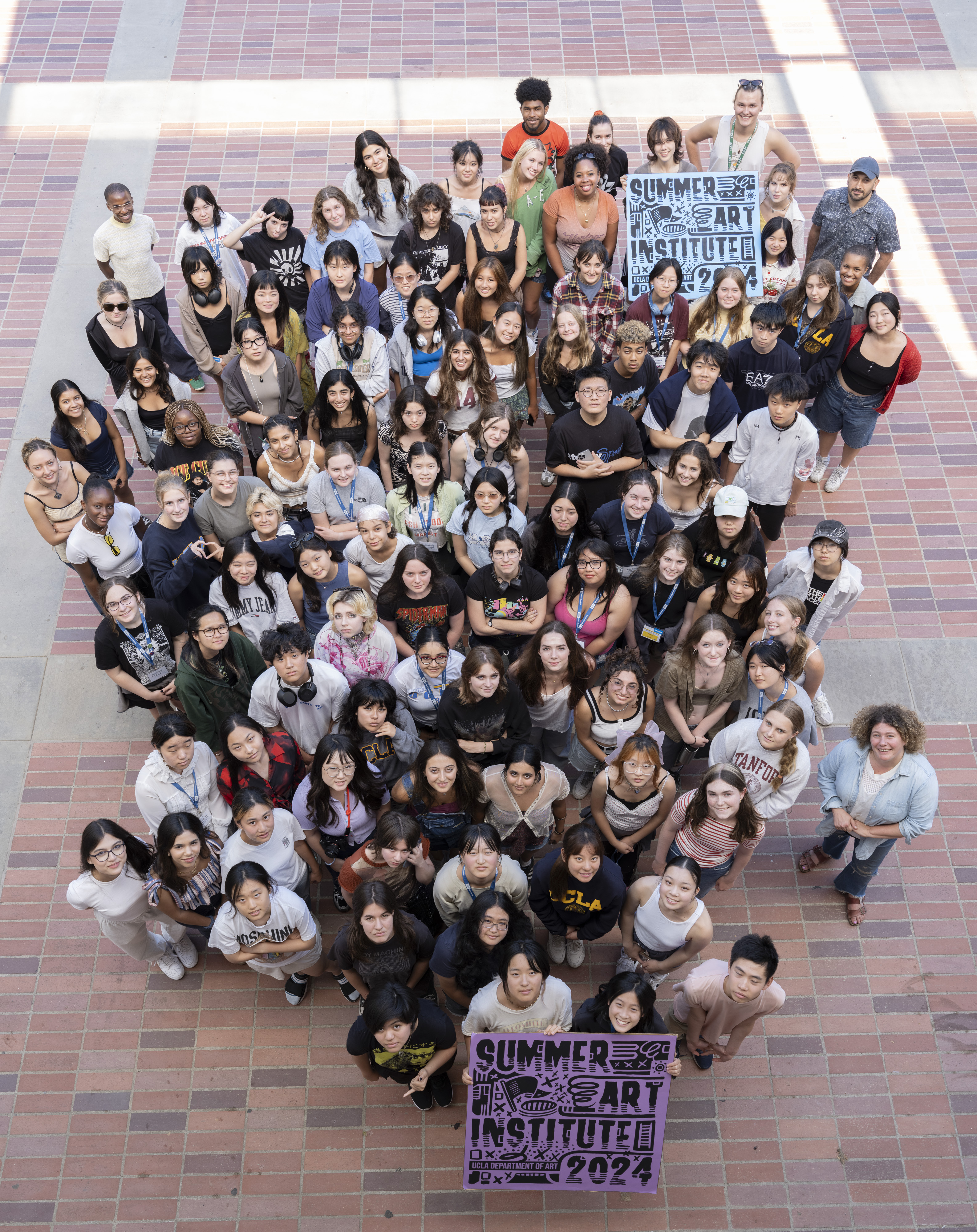 Group of students standing on a brick ground, photographed from above